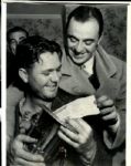 Sam Snead looks at Check. Wire Photo - 2/14/38