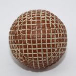 A Red Painted Silvertown Mesh-Patterned Gutty Golf Ball
