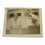 Maureen Orcutts Original in Augusta (Montell)Photo - With Gentleman Holding Golf Bag with Clubs