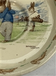 A Pair of Royal Doulton Bunnykins Ceramic Golfing Tableware Items by Barbara Vernon
